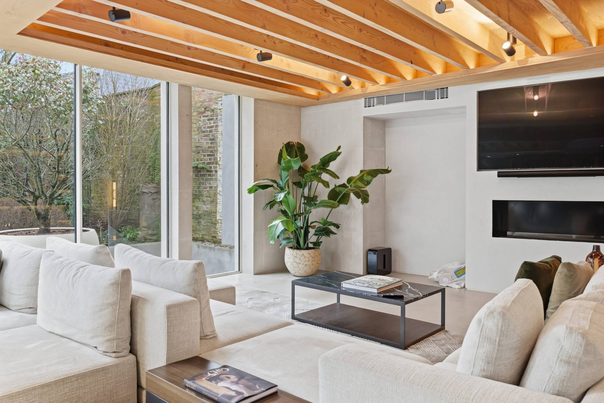 Living Room Renovation Battersea | Excel Construction Living room with timber beam ceiling, fireplace and garden views, Battersea, by Excel Construction