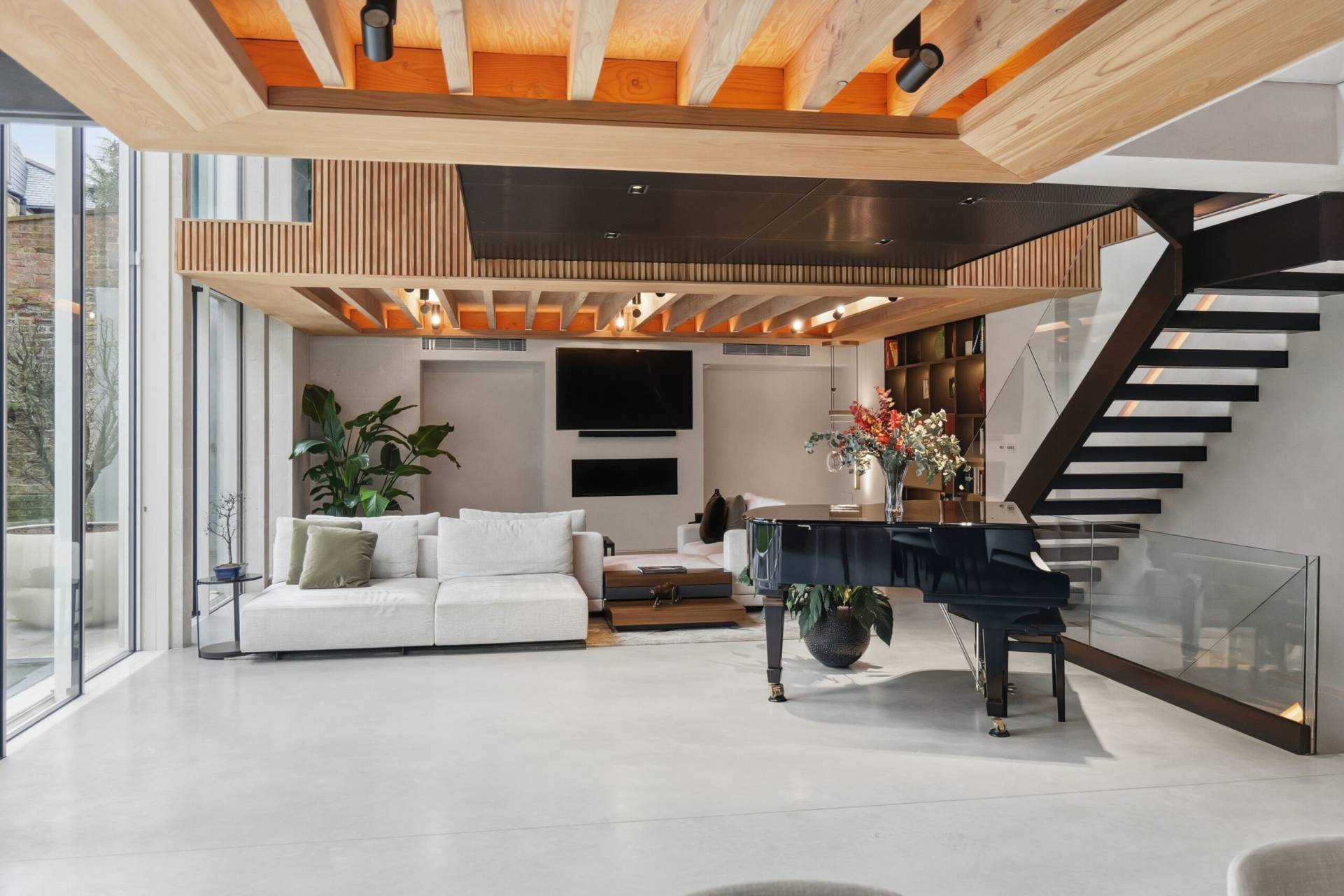 Luxury Home Renovation Battersea | Excel Construction Open-plan living area with timber beam ceiling and floating staircase, Battersea, by Excel Construction