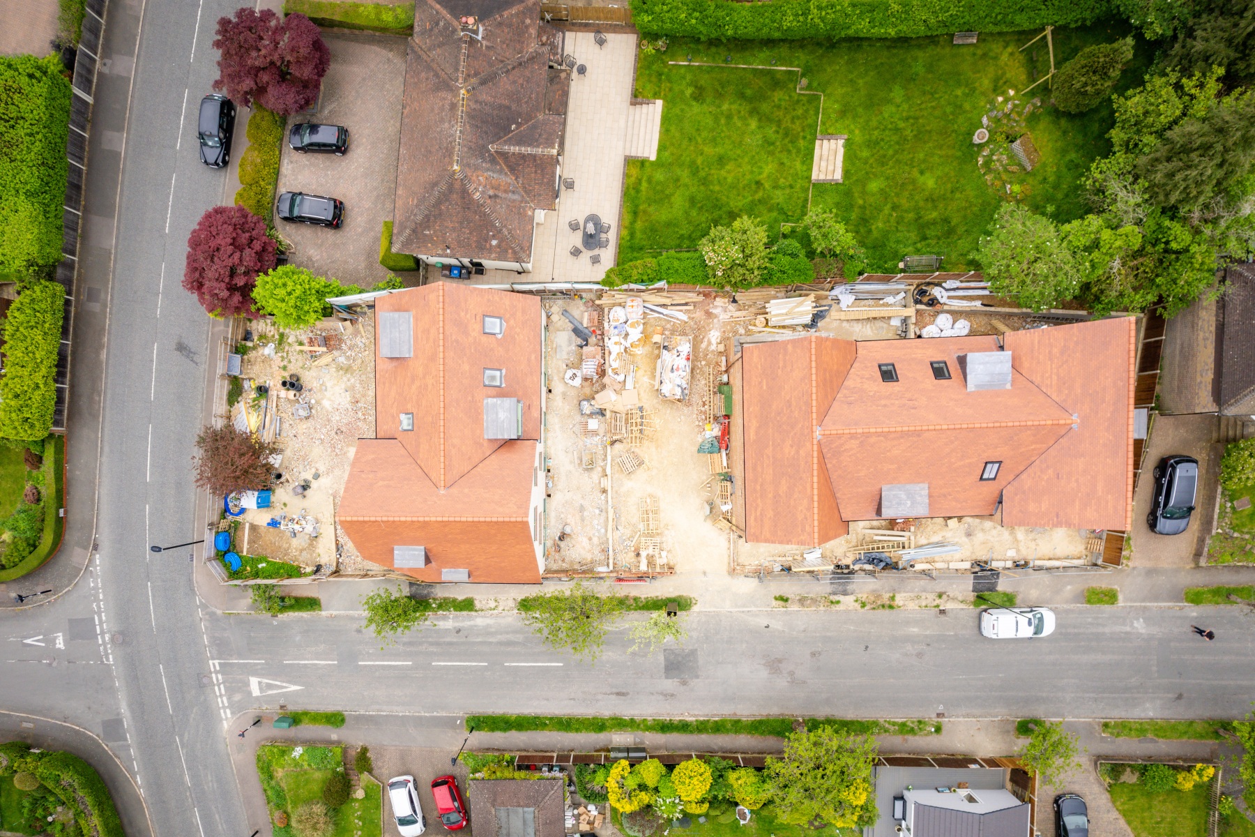 Overhead drone view of the housing development at 158 Purley Downs Road, South Croydon, showing tiled roofs, rooflights and ongoing construction