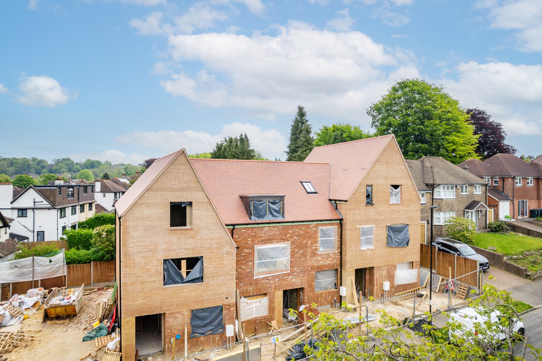 Street view of the new-build housing development at 158 Purley Downs Road, South Croydon, with pitched roofs and surrounding trees.