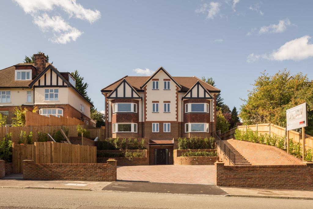 Front elevation of a nine-flat new-build development in South London, with brick and rendered façades.
