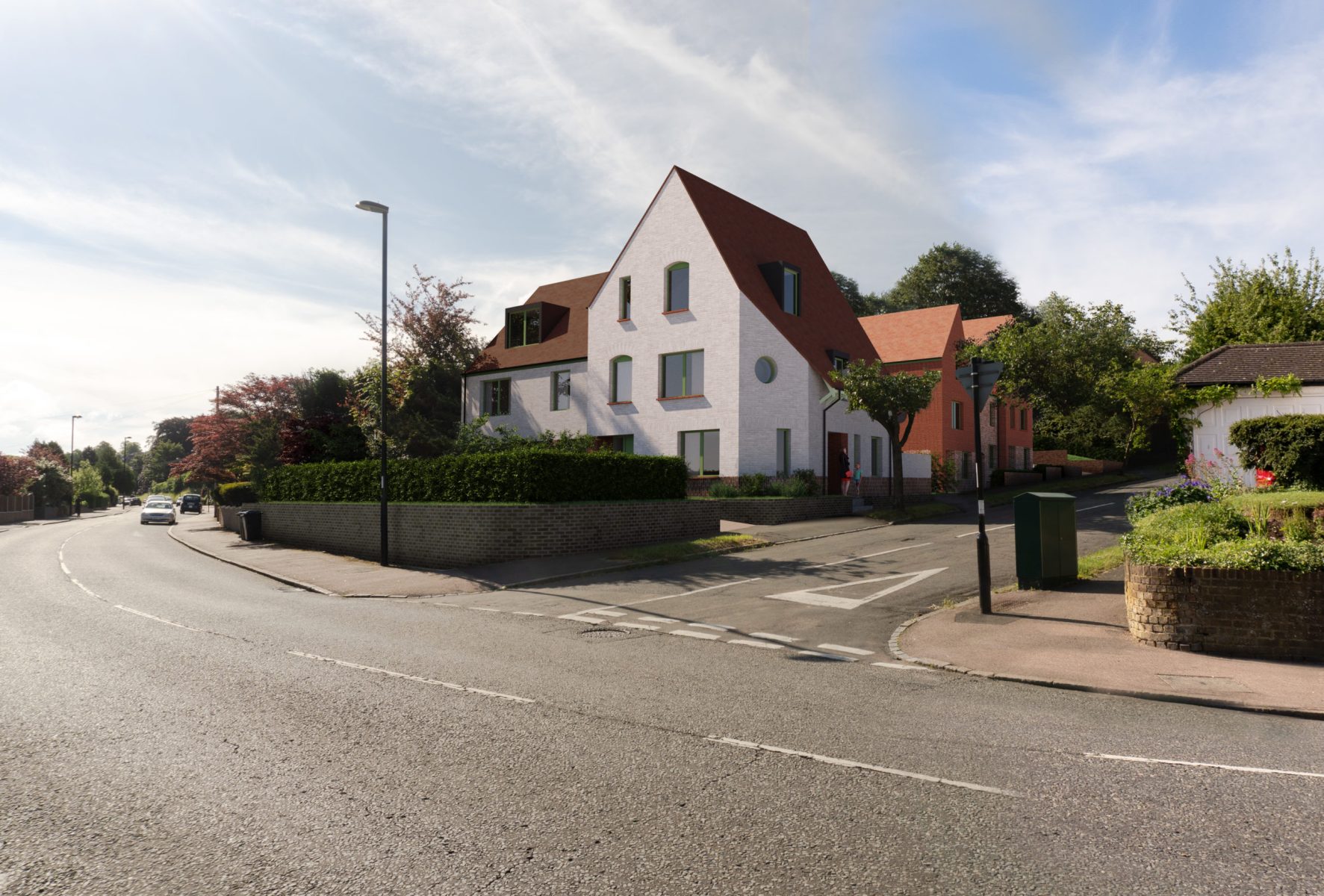 Street view of the new-build housing development at 158 Purley Downs Road, South Croydon, with pitched roofs and surrounding trees