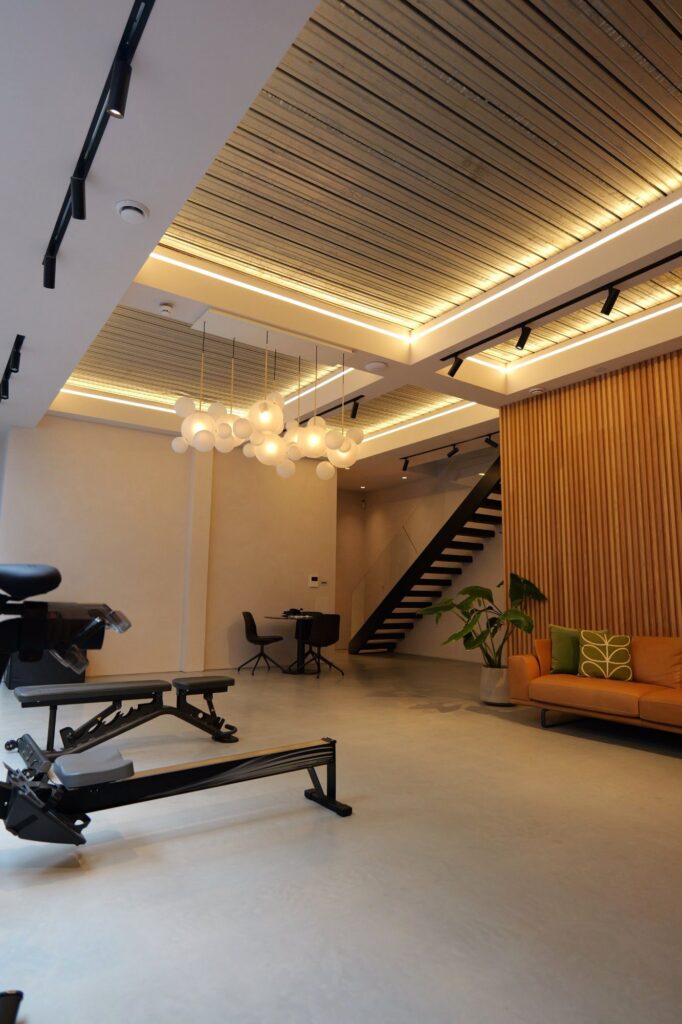 Open-plan basement with slatted timber wall and open staircase, 31 Edna Street