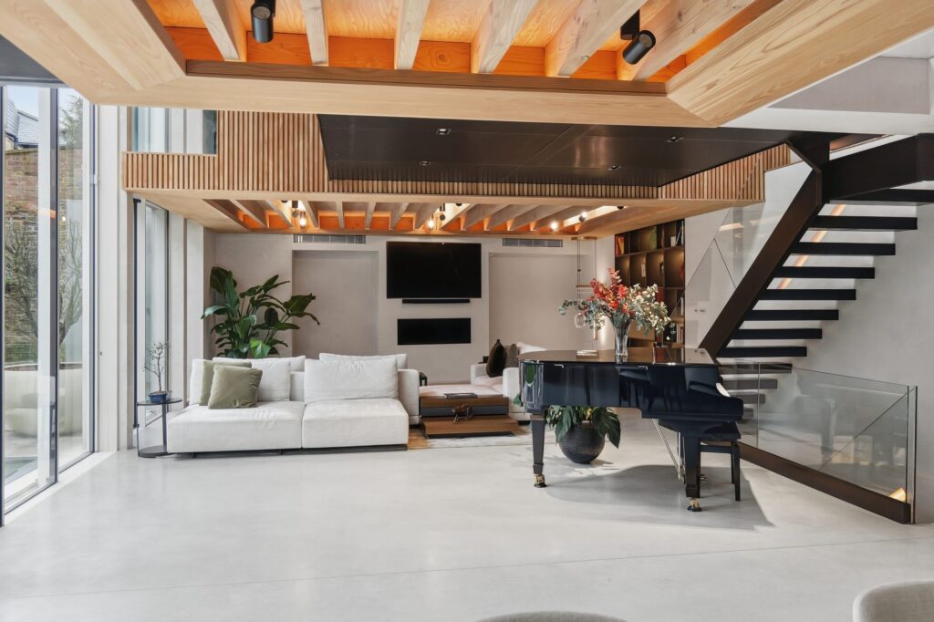 Double-height living room with open steel staircase, 31 Edna Street, Battersea