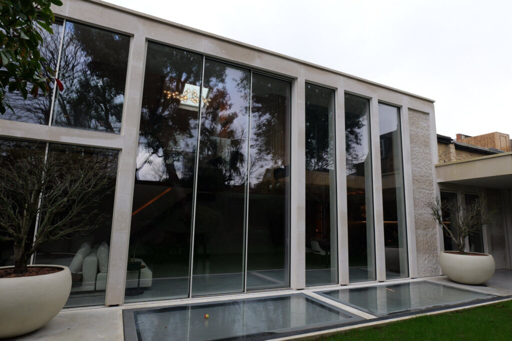 Rear elevation of 31 Edna Street, Battersea, with double-height glazing in a stone frame