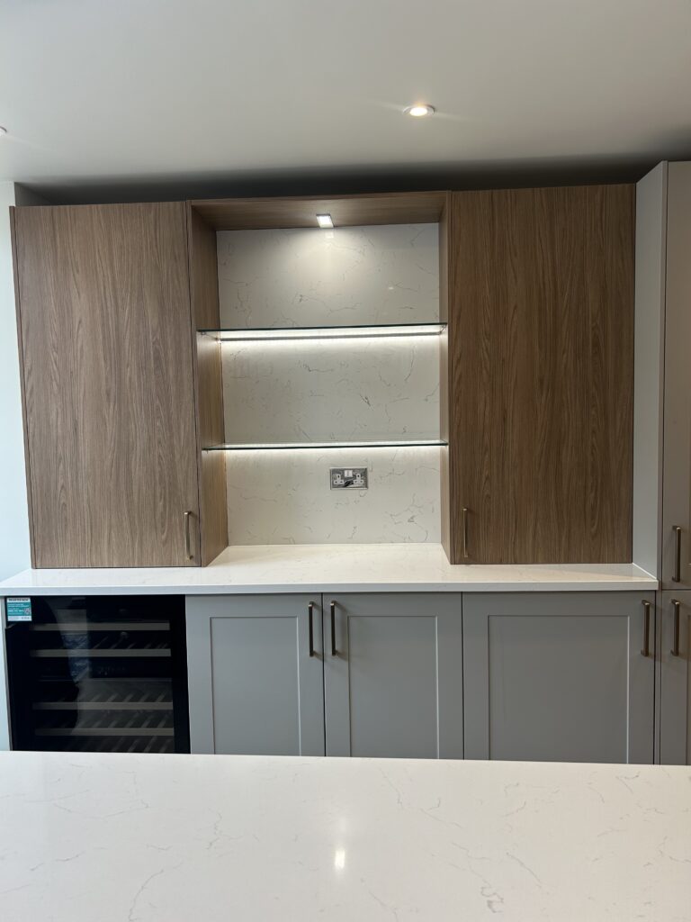 Häcker kitchen with central island, quartz worktops and Amtico herringbone flooring at Massingberd Way, Tooting.
