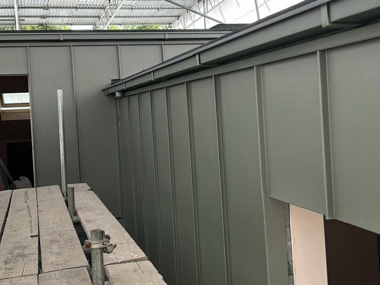 Sage green standing seam aluminium cladding on a loft dormer by Excel Construction in Honor Oak, South London