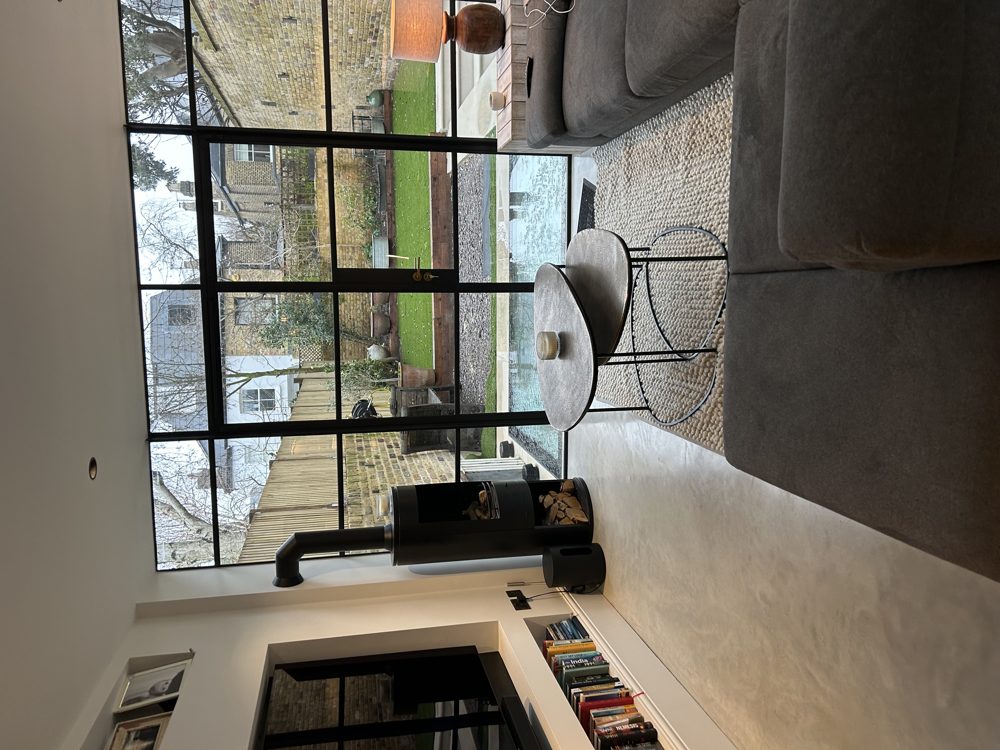 Steel-framed Crittall-style doors and wood burner in the rear living space